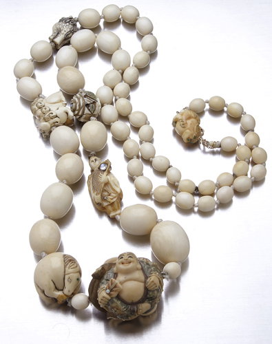 Ivory bead necklace with gem-set netsuke, graduate