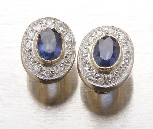 14K yellow and white gold earrings having oval fac