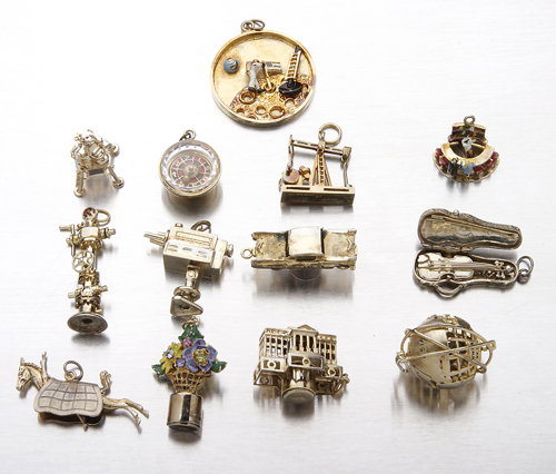 Thirteen vintage mechanical or illuminated charms