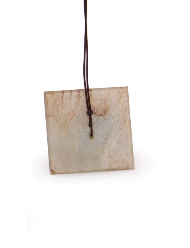 A Chinese brown and white jade square plaque: Finely decorated with landscape. W. 5cm.