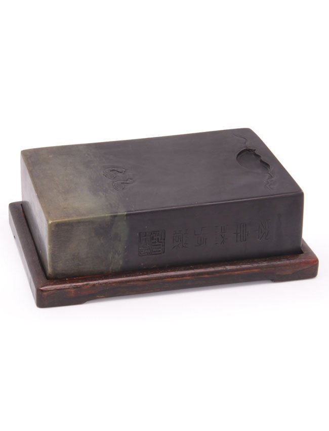 A Chinese Duan inkstone: Decorated with two ducks, the side with calligraphy and encased in custom fit case and cover. L. 15cm.