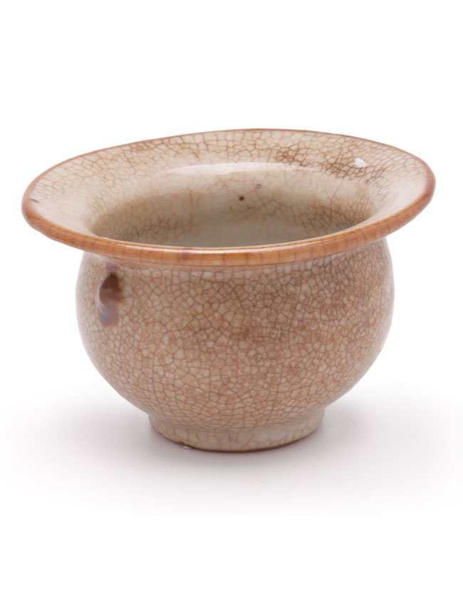 A Chinese porcelain spittoon: Covered in a crackle cream/brown glaze. 11.2cm.