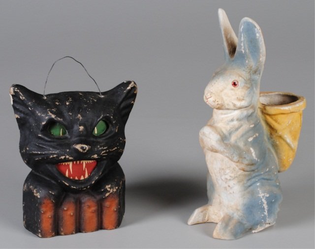 Two Pieces Papier Mache, Holiday Related: Halloween cat lantern, paper insert eyes/mouth intact, c.1930's, 7 x 6" (some paint loss, one ear chip); Easter Rabbit with open basket, 10"h (some paint loss, water stains @ basket) Provenance: Joe L