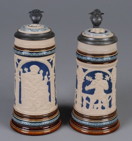 Two Mettlach Steins: .5L, 2130, relief, inlaid lid, Gambrinus; .5L, 2131, relief, inlaid lid, barroom characters Provenance: Dennis Galloway Estate, Etowah, NC