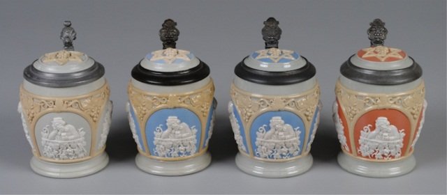 Four Mettlach Steins: .5L,1266, relief, inlaid lid, three panels with drinking scenes, two with blue background, one terra cotta background, one gray background (interior staining, loose strap) Provenance: Dennis Galloway 