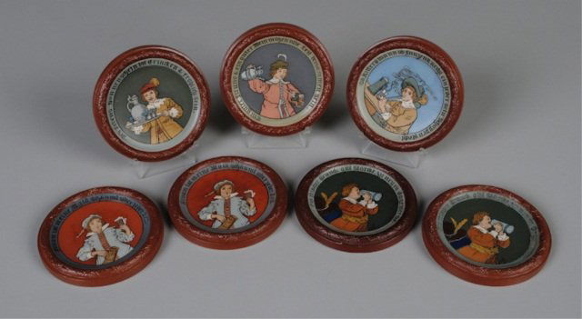 Seven Mettlach Coasters by Quidenus: 4.5", etched: 2817, waiter serving wine; 2819, Cavalier smoking pipe; two 2820, Cavalier holding glass and pitcher; 2821, Cavalier pouring wine; two 2822, Cavalier drinking from stein Provenance: Denn