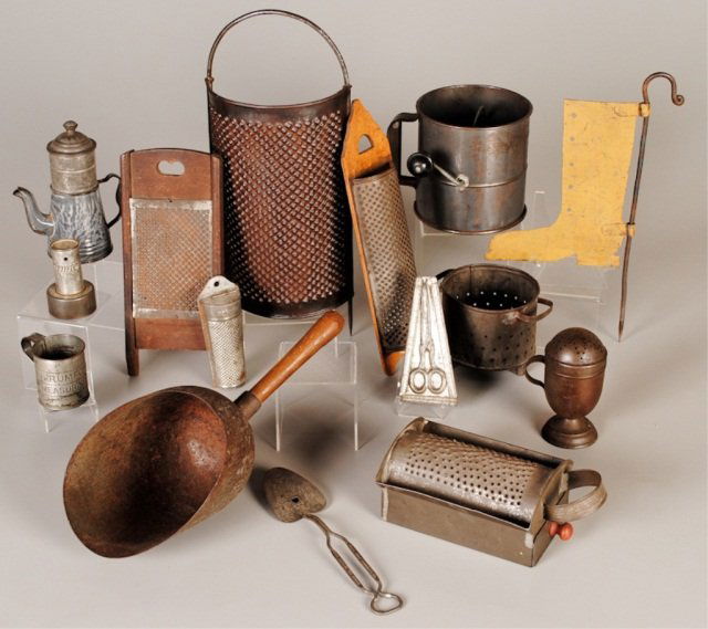 Fourteen Pieces Tinware: four graters, Kreamer flour sifter, flour dredge, large wood handle scoop, gray enamelware coffee biggin, Kreamer nutmeg grinder, strainer, Rumford advertising biscuit cutter & measuring cup, Ideal Mi