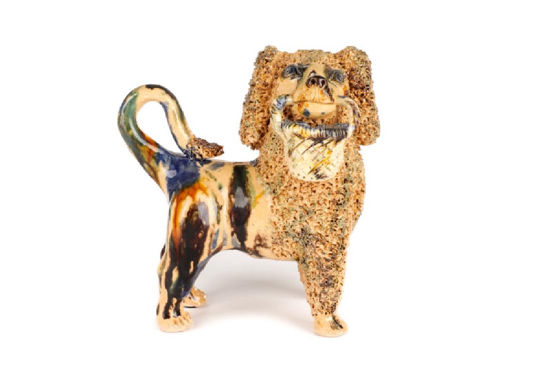 Signed Bill Ray Hussey Ceramic Poodle with Basket: Billy Ray Hussey (American, Robbins, North Carolina, born 1955), circa 1980s. A molded and stoneware green, cobalt, and mustard lead glazed poodle with a basket. Signed to underside. Approximate heigh