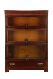 Globe Wernicke “Elastic" Sectional Bookcase: Globe Wernicke Company (American (Ohio) 1893-1987), first quarter 20th century. A Mission pattern barrister or 'elastic' bookcase having three sections with glass lift doors, over a single base drawer