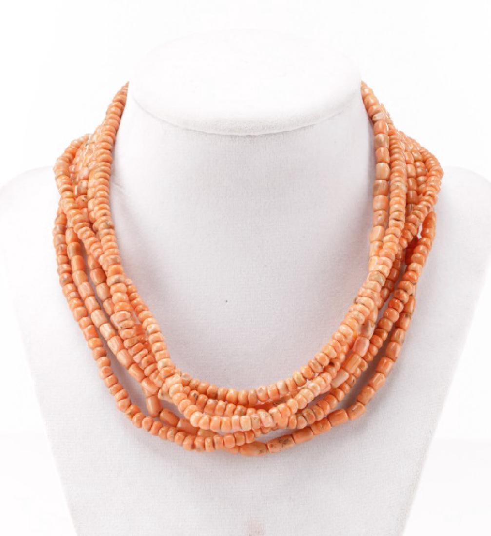 Long Beaded Pink Coral Necklace: A necklace of graduated pink coral beads with a gold-tone screw clasp. Apparently unmarked. Length 97".
