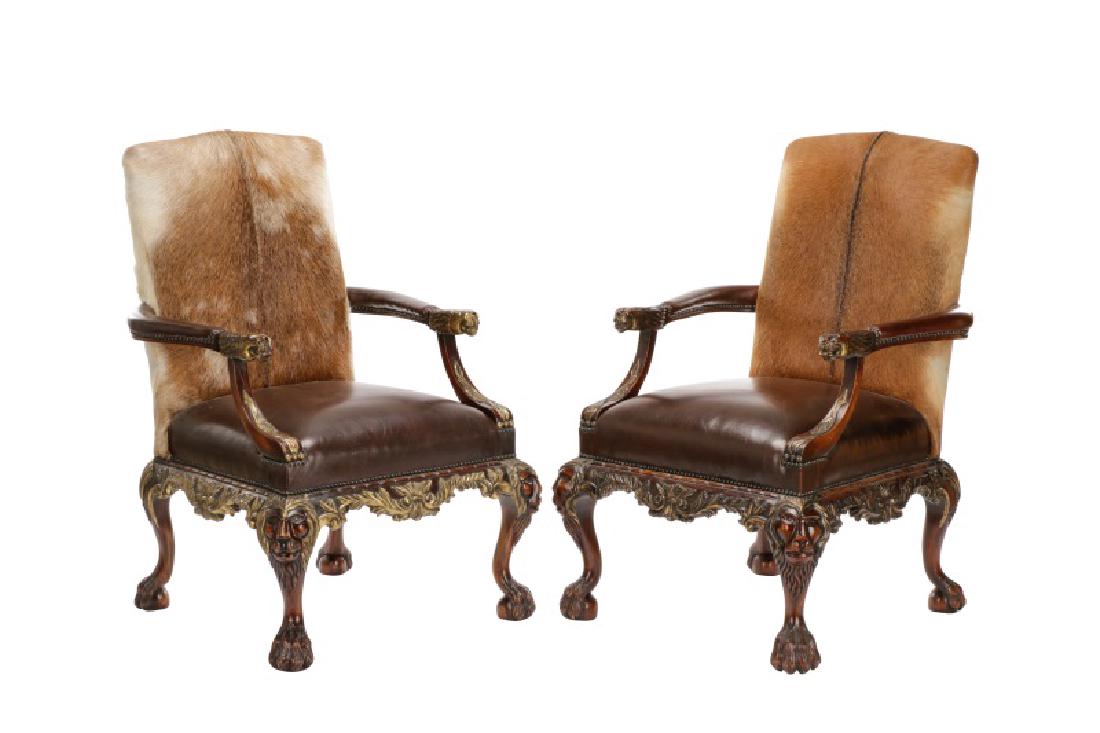Pair, Louis XIII Style Cowhide Throne Chairs: Continental, late 20th century. A pair of Louis XIII style throne chairs, each having a cowhide upholstered seat back over a dark brown upholstered leather seat, with curved upholstered arms with deco