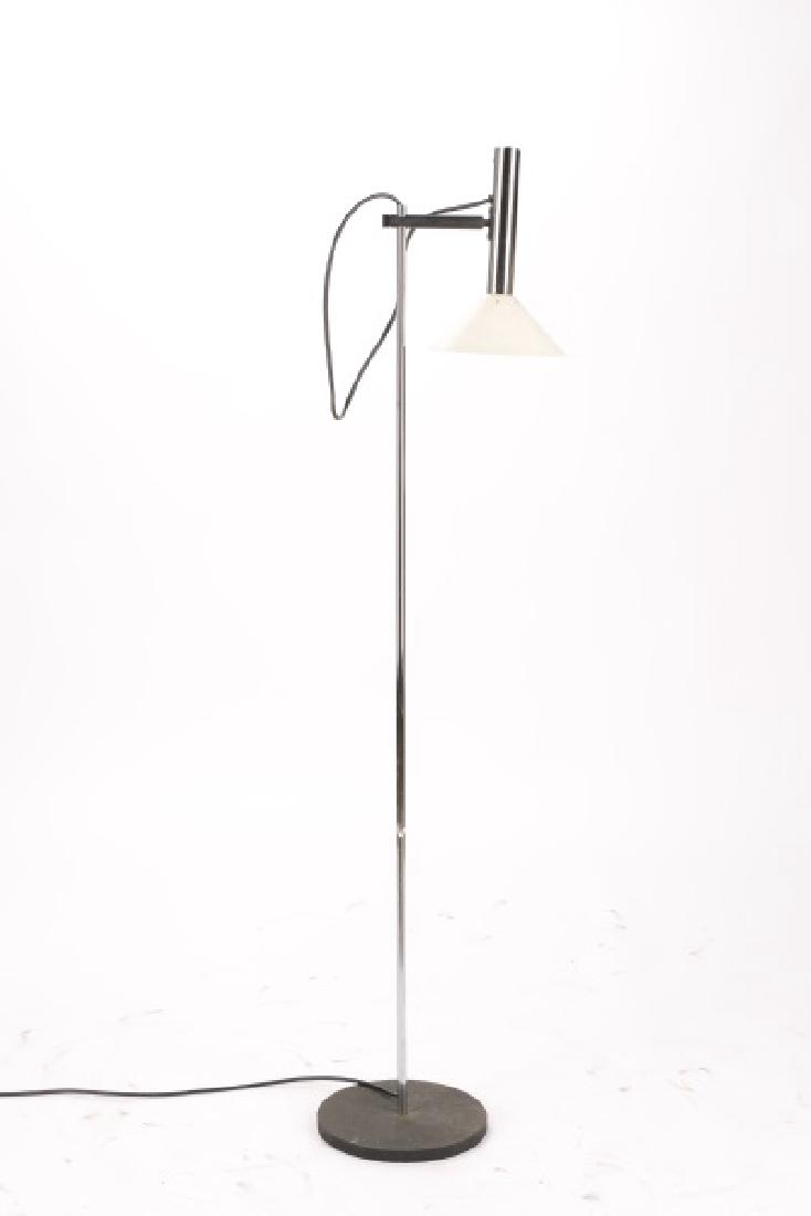 George Kovacs Chrome Floor Lamp, Labeled: George Kovacs (American, 20th century). Modern floor lamp with pierced white conical shade below adjustable chrome cylindrical mount, thin cylindrical shaft terminating on black cast iron base. Labele