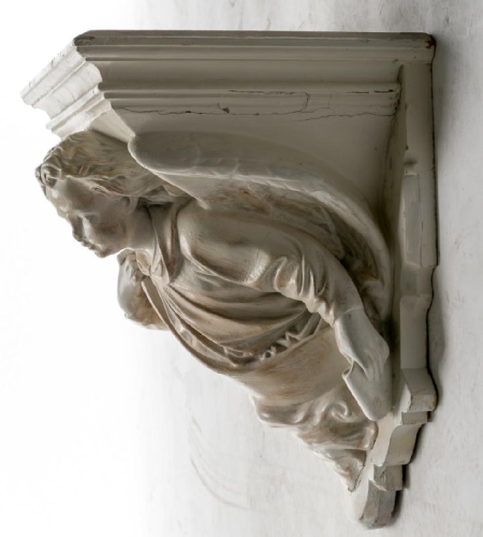 American Carved Wood Angel Form Corbel: American, early 20th century White painted carved wood corbel in the form of an angel, inscribed to back "St. Ann's Church in Hornellsville, NY" Approx height 18", width 14.5", depth 12.875"