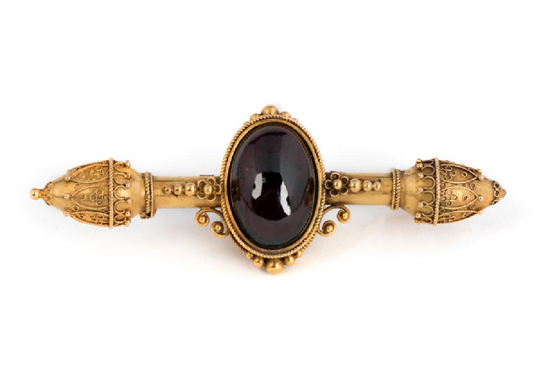 Victorian 18k Rose Gold & Garnet Pin or Brooch: A handmade Victorian broach or pin, circa late 19th century, set in 18k rose gold with a 24k gold satin finish plating, having one garnet (Approx. 16mm x 11.5mm, color: dark red). Apparently unmarked,