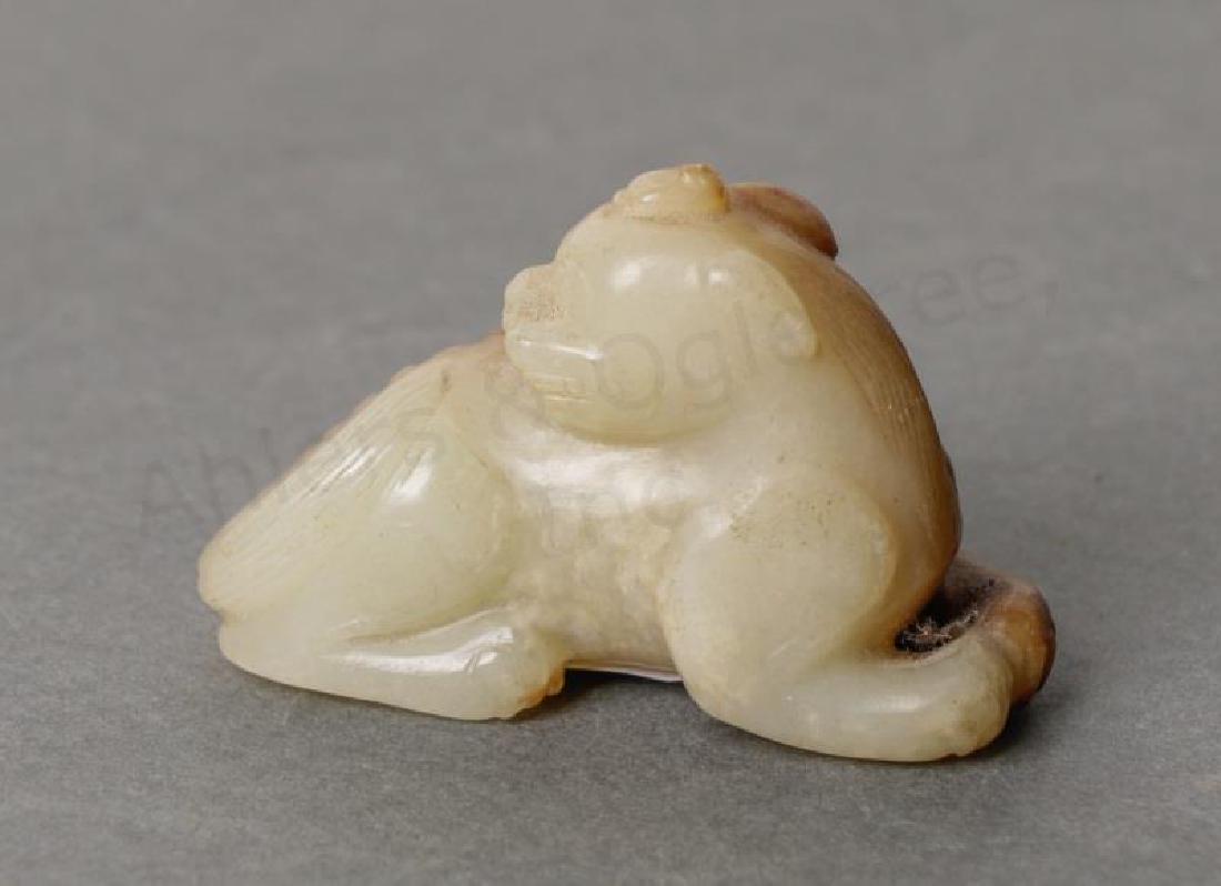 Chinese Ming White & Russet Carved Jade Qilin: Chinese, Ming Dynasty A white and russet carved jade seated Qilin Unmarked Approx. 1.625", w. 2.375"