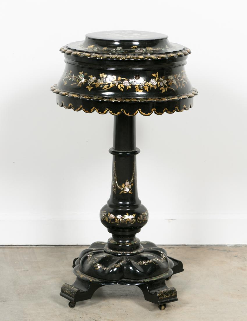 English Black Lacquered & Pearl Inset Sewing Stand: English, late 19th / early 20th century A Papier Mache black lacquered round sewing box on stand having scalloped edges with mother of pearl inlay and gilt floral decoration. Insert has red velvet com