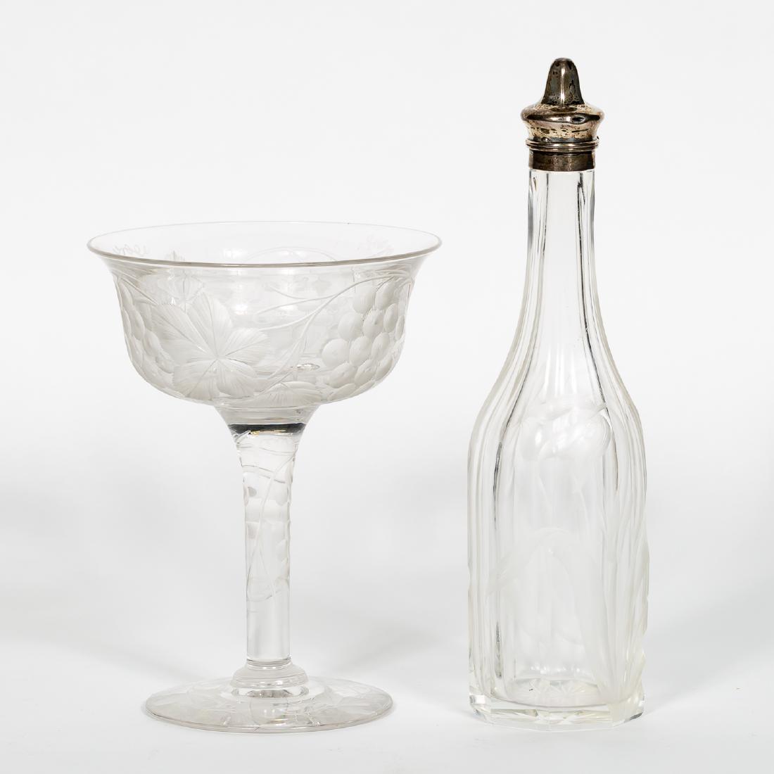Intaglio Cut Glass Compote & Bottle: Tall intaglio cut compote decorated with grapevines and grapes together with an intaglio floral decorated bottle bearing a sterling cap and unidentified marks to bottom. Approx. height of bottle 11", 