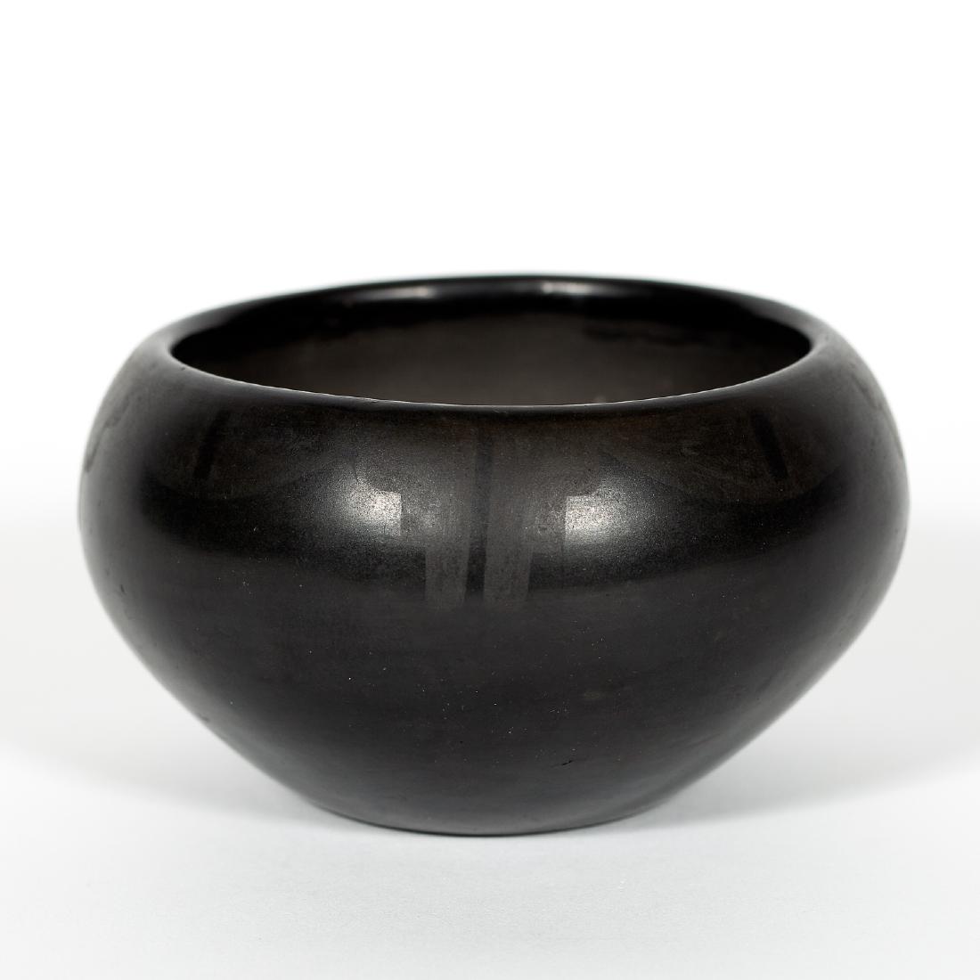 Marie & Julian Martinez San Ildefonso Small Bowl: Small Native American bowl created by Maria and Julian Martinez, featuring a matte black design on black pottery. Singed to the underside "Marie & Julian". Approx. height 2.6", opening diameter 3.65".