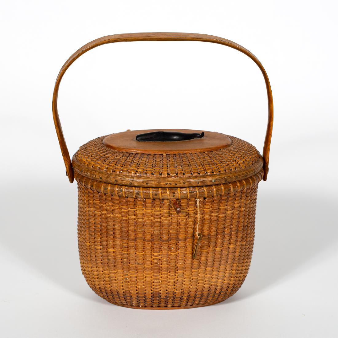 Jose Reyes Nantucket Basket Handbag, Signed: Jose Formoso Reyes (Phillippine/American, 1902-1980). Nantucket Basket Handbag, CA 1960, Wood and Rattan, signed on base. Typical oval lidded form with Ebony carving of a whale applied to top. Bentwoo