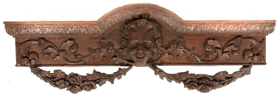Pair Oak Pelmets w/ Grotesque Masks & Swags: Likely English, 19th C. Pair of oak pelmets (also called a "cornice board") carved with central grotesque mask issuing leafy flloral swags. Approx. height 15", width 51.5", depth 7.62".