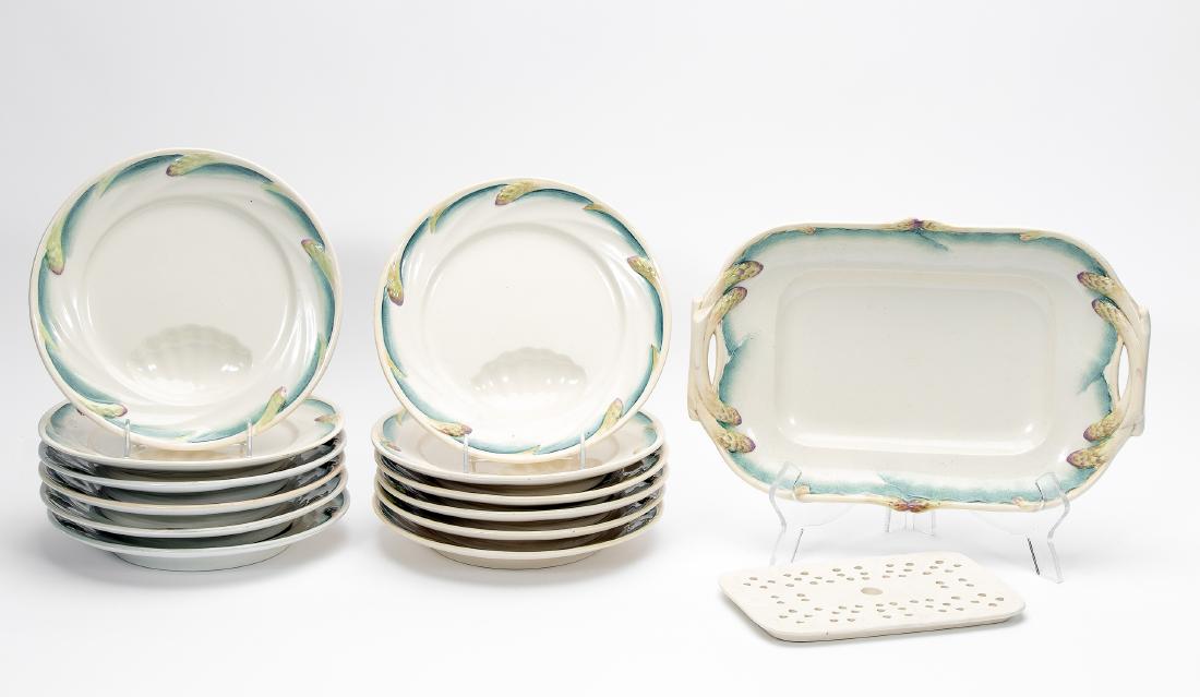 13pc Sarreguemines Asparagus Service, 1875-1950: Sarreguemines. Asparagus server and dish set comprising platter with drain and 12 round plates with sauce well. 4 plates with 1875-1900 makers mark, 8 plates with 1920-1950 makers mark, some also with