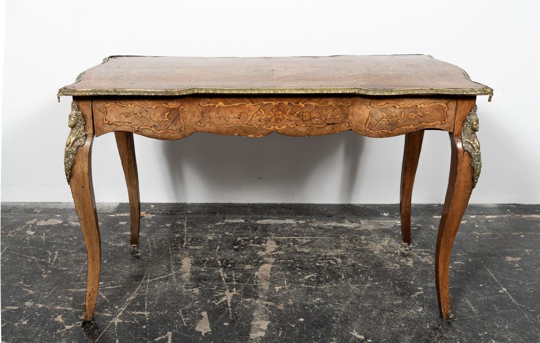 French Louis XV Style Marquetry Bureau Plat: French Louis XV style marquetry bureau plat. 20th cent. overall floral inlay with egg & dart brass mounts to the edge and figural mounts to the cabriole legs with sabots. Approx. w. 48.25", h. 30", d.