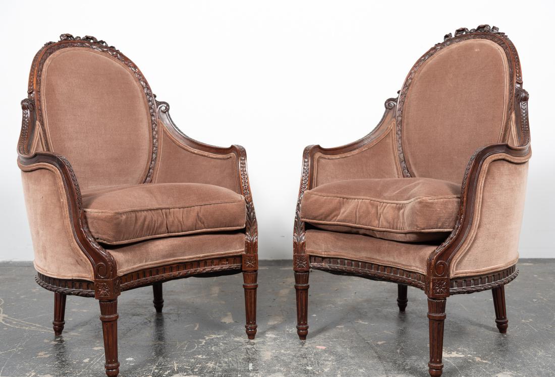 Pair, Louis XVI Style Bergeres a Dossier Cabriolet: Pair, Louis XVI style bergeres a dossier cabriolet. 20th century, mahogany frame, oval back with ribbon carved crest, leaf and berry carving, curved enclosed sides and seats on tapered and fluted legs