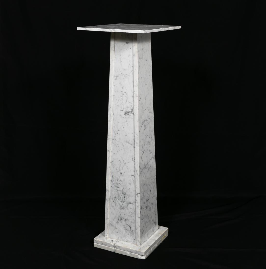 Carrera Marble Pedestal or Plant Stand: Carrera marble pedestal or plant stand. Square top with a square spreading shaft on a conforming plinth. Approx: w.12", h. 37.5", d. 12". Provenance: From the Private Collection of Daniel Bibb, Atlant