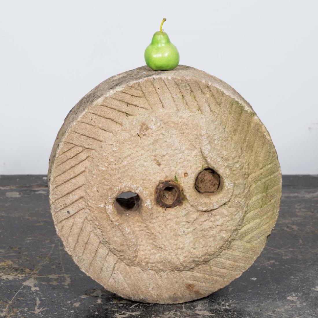 19th Century Chinese Limestone Millstone: Chinese, 19th century; pierced center with radiating geometric carving. Approx. d. 23, h. 6.25".