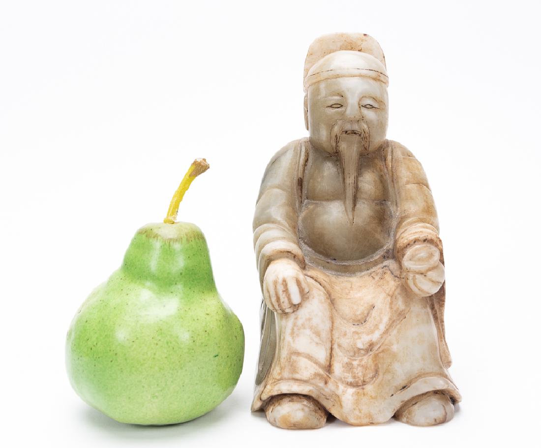 Carved Chinese Onyx Figure of a Seated Elder: Carved Chinese onyx figure of a seated elder or scholar. Depicted wearing headdress, goatee and pouch in one hand. Unsigned. Approx. w. 4.125", h. 7.5", d. 4".