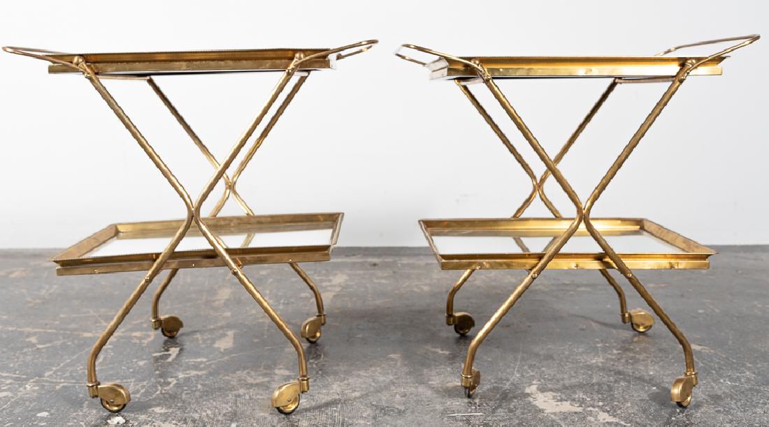 Pair, Italian Two Tier Brass & Mirror Bar Carts: Italian, 20th century. Pair, two tier brass & mirror bar carts. Gadrooned edge with mirrored surfaces, "X" frames on four brass capped wheels. Marked "Made Italy" to side. Approx. of each w. 16.25", h