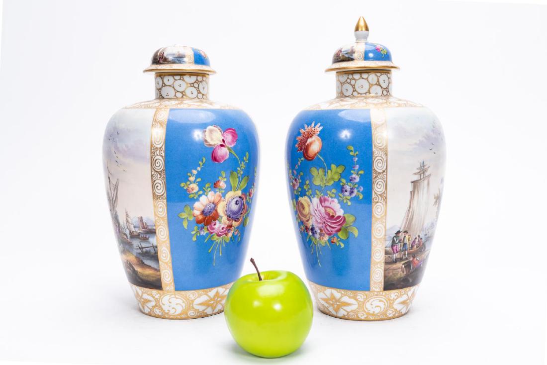 Pair, 19th C. German Carl Thieme Porcelain Urns: Late 19th to early 20th century. Carl Thieme (German, founded 1864); Dresden porcelain; powdered blue ground panels with polychrome florals alternating with German river scenes. Makers mark for 1888-1