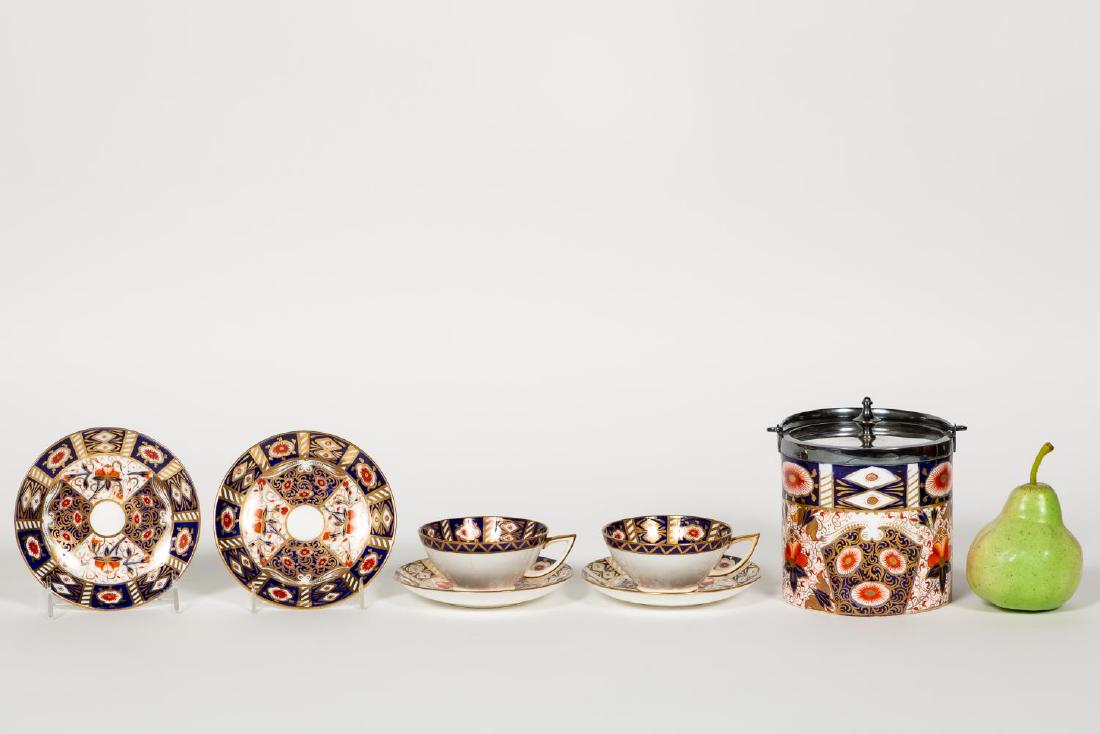 English Imari Biscuit Barrel and Teacups, 7 PCS: Seven pieces, English; gilded blue and rusts floral pottery and bone china; consisting of an E.J.D. Bodley (English, 1875-1892) biscuit barrel with silver plate mounts, together with two tea cups and 