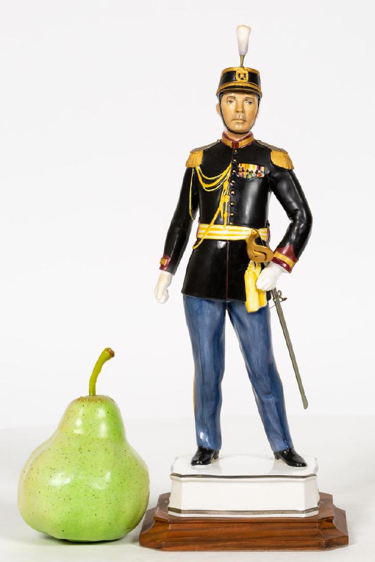 Royal Worcester Officer of the Palatine Guard: Royal Worcester (English, founded 1751). A "Papal Series: Officer of the Palatine Guard" bone china figurine on base; modelled by Neal French; number 61. Marked on underside. Approx. height on stand o