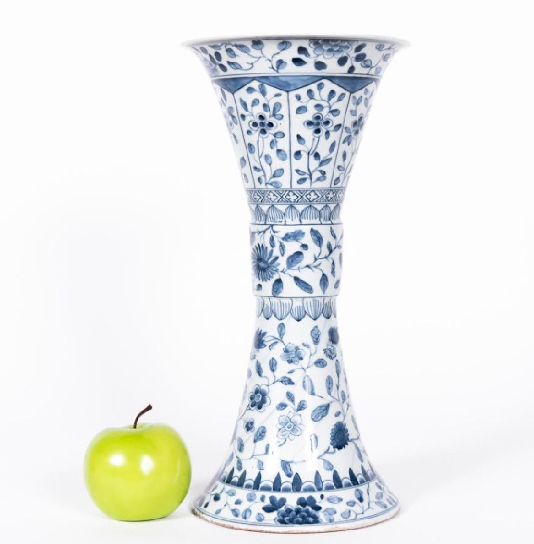 Chinese Gu Blue & White Floral Motif Vase: Chinese. A blue and white "Gu" beaker porcelain vase with floral decoration. Six character Qing dynasty Kangxi blue mark. Approx. h. 14.5", diam of opening 17.25". Provenance: From the Private Collect