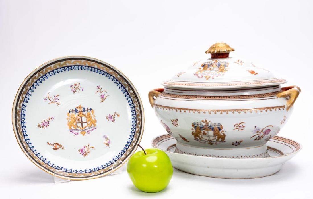 3 Pieces Chinese Export Style Armorial Serveware: 20th century, Chinese; porcelain; consisting of a tureen,underplate and charger; white ground with gilt trim, scattered florals and fantasy armorials. Unmarked. Approx. of the tureen, w. 14", h. 10",