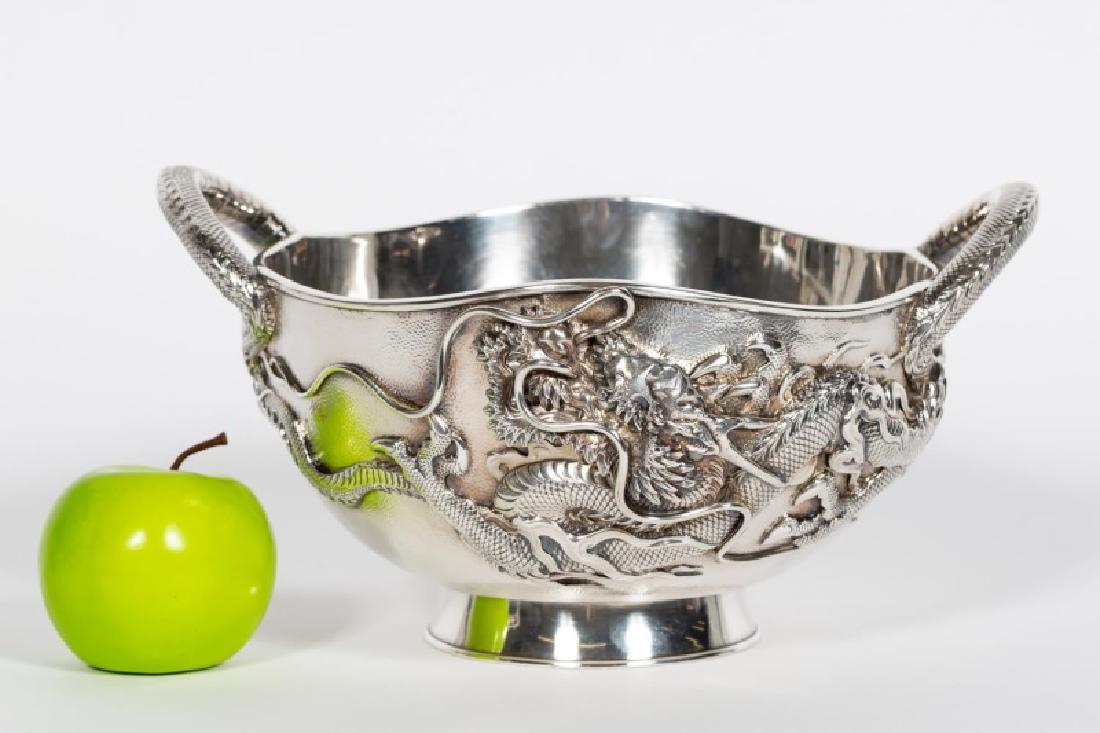 Meiji "Sanju Saku" Repousse Silver Dragon Bowl: An antique Meiji period repousse silver dragon bowl. The bowl features two intricately sculpted silver dragons wrapped around the bowl with their body forming handles to each side. The bottom has a tw