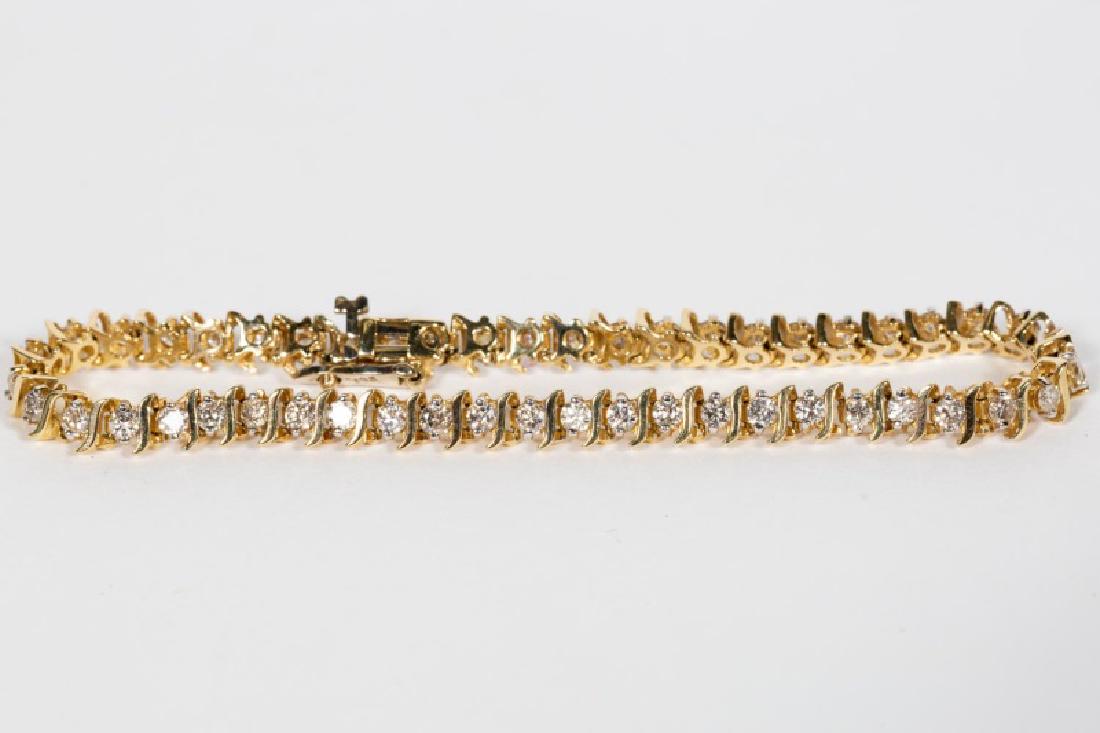14k Yellow Gold & Diamond Tennis Bracelet: A ladies 14k yellow gold tennis bracelet with "S" link style, set with 49 modern round brilliant cut diamonds (approx. 2.50 ctw, I-J color range, Si1-Si2 clarity range). Circa 1980's. Marked for 14k g