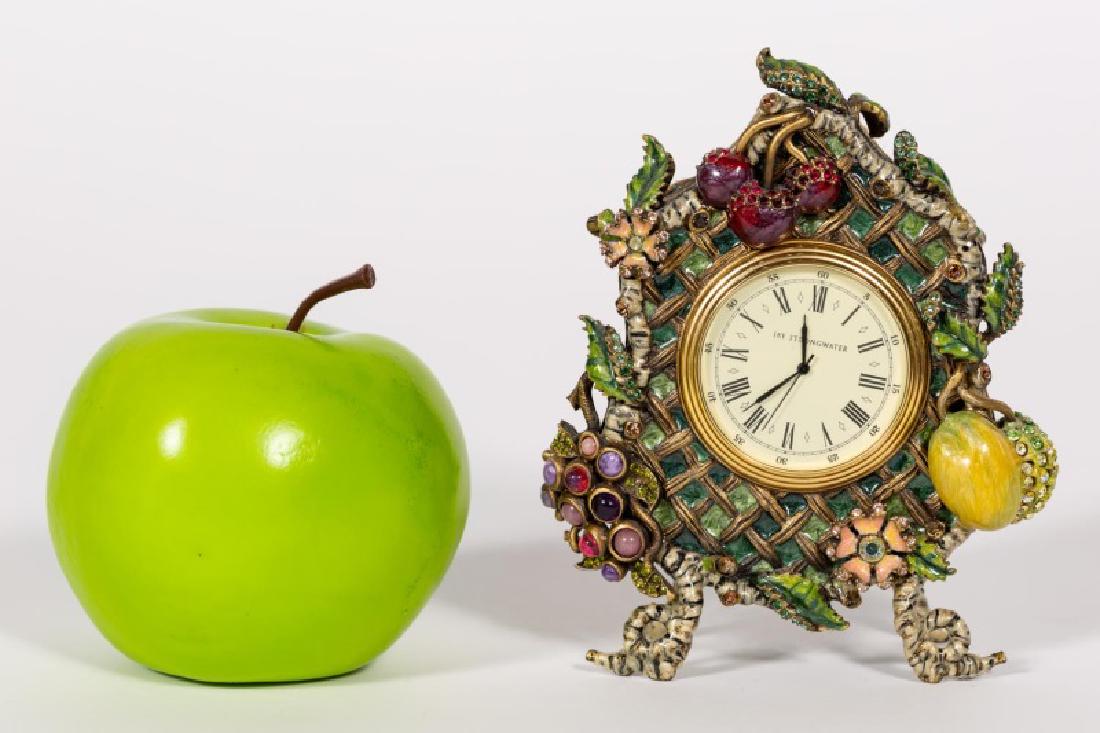 Jay Strongwater English Garden Enameled Desk Clock: Jay Strongwater (American, 20th Century). Enameled desk clock with a trellis under wire accented with Swarovski jeweled fruit, butterflies and floral decorations. Marked to backside. Approx: 5.25" H x