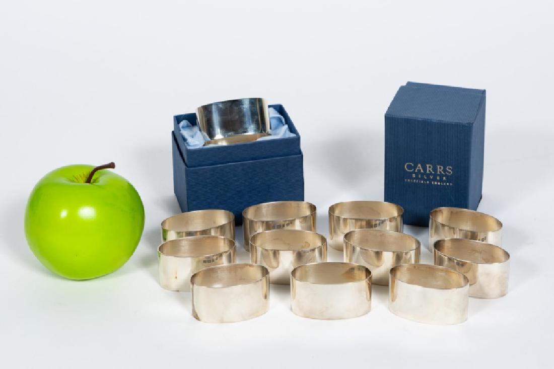 Set of 12 Carrs English Sterling Napkin Rings: 21st century; Carrs Silver (Sheffield, founded 1977); twelve sterling silver plain oval napkin rings. Marks for Sheffield and 2006. Approx. of each w. 2.125", h. 2.125", d. 1.125"; approx. total weigh