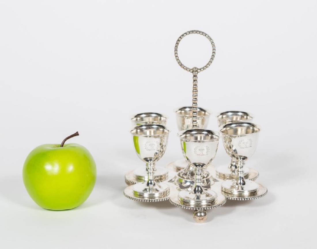 Victorian English Sterling Silver Egg Stand: Mid-19th century, English, sterling silver, egg stand with 6 cups. Hallmarked London, 1859, maker's mark for Daniel & Charles Houle. Each cup with engraved crest, spool motif center ring handle and ba