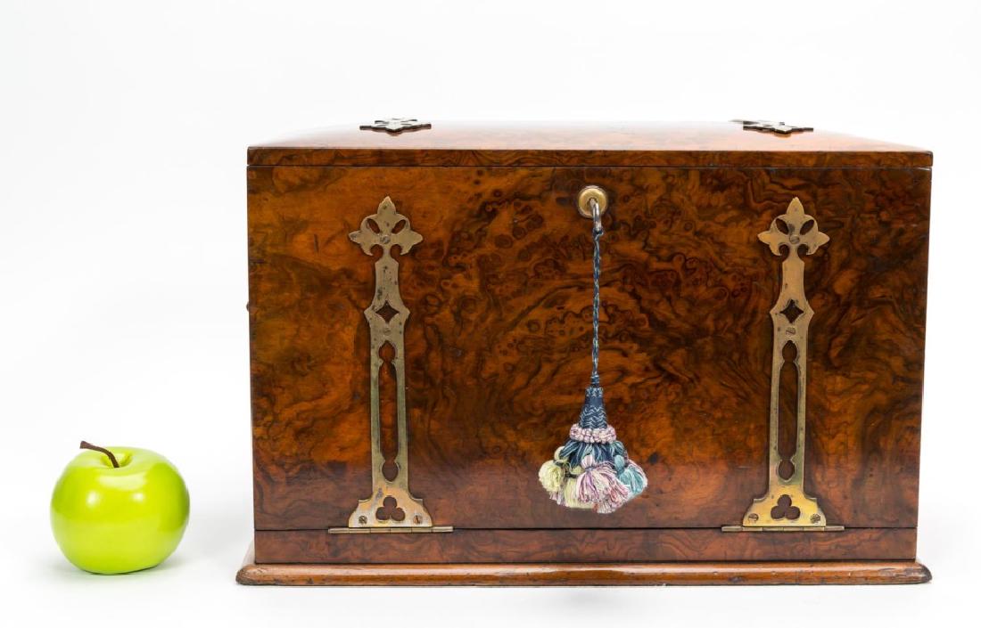 Gothic Revival Burl Mounted Traveling Letter Box: English, late 19th century; burl walnut with ormolu straps and hardware; rectangular form with domed lid; the interior fitted with multiple compartments and folding writing surface. Approx. closed, w.
