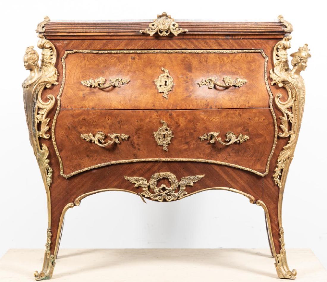 French Regence Style 2 Drawer Commode en Arbalete: 20th century, French; burl inlaid wooden case; having a shaped marble top; swelled sides with two drawers with foliate hardware; flanked by figural bronze mounts; serpentine apron; rising on cabriole 