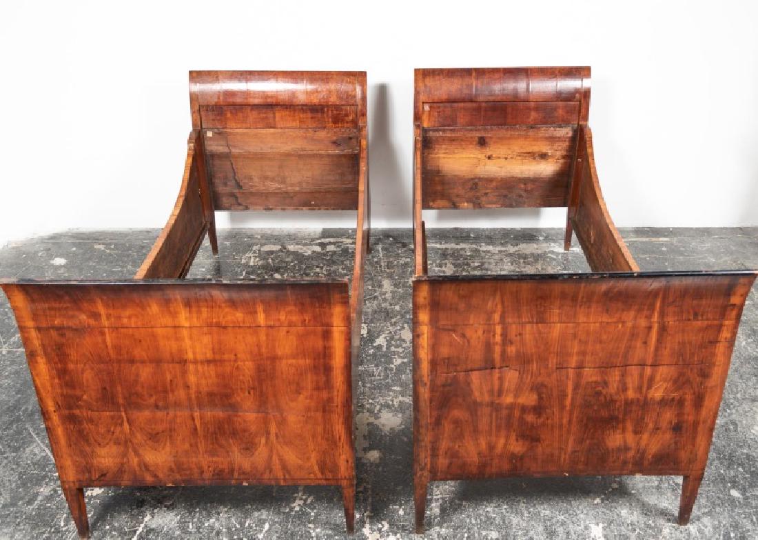 Pair, French Louis Philippe Twin Sleigh Beds: Mid 19th century, French; curved mahogany veneered head and foot boards with ebonized crests; curved side rails; rising on tapered feet. Approx. of one, h. 39", w. 34.5", d. 78"; interior, w. 31.75", 