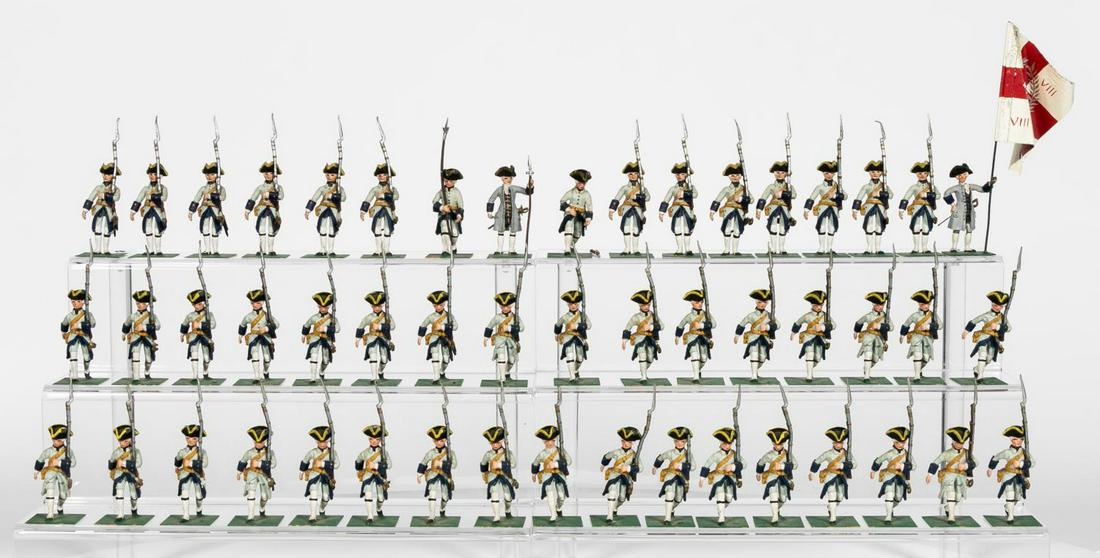 50 Pc, Stadden Studio "British 8th Army" Soldiers: Charles Stadden Studio (English, 20th century). Amassive group of fifty British 8th Army toysoldiers marching for battle. Apparently unmarked.Approx: h. (measures flag) 6.5". Provenance: From the Esta