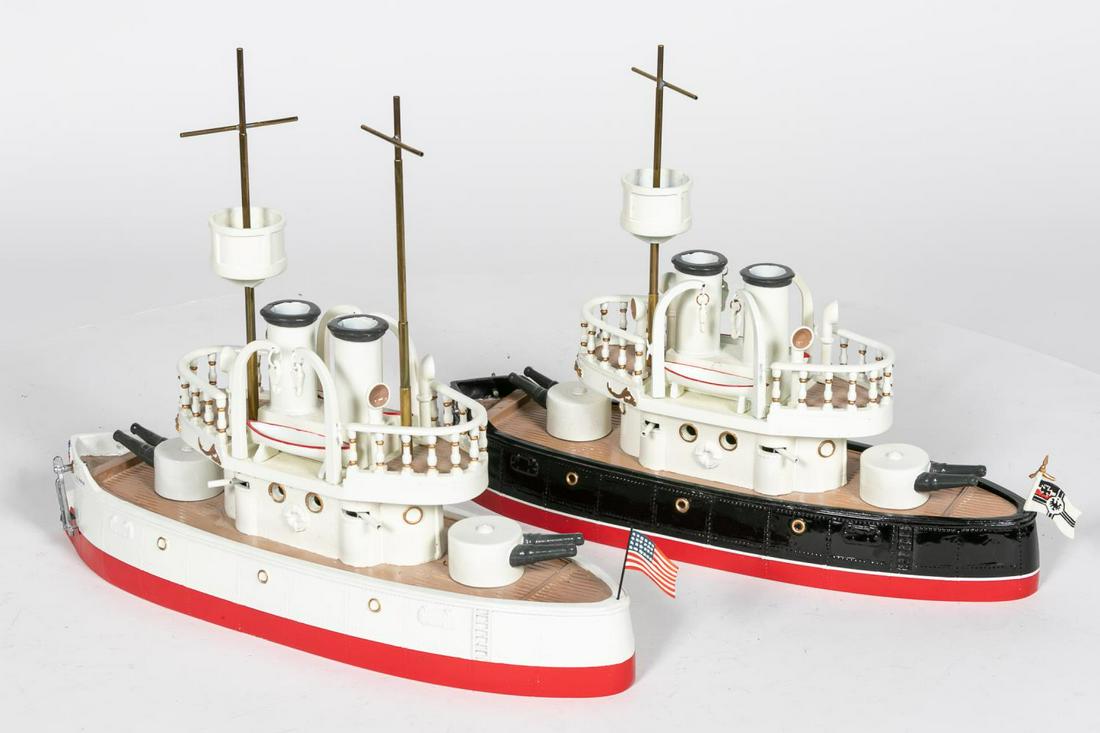 Two, Hand Painted American & German Battle Ships: 20th century. Two hand painted American & Germanbattle ships "Olympia" and "Deutschland".Apparently unmarked. Approx: h. 11.5", w. 14.5". Provenance: From the Estate of Charles Michael Cawley of Bever