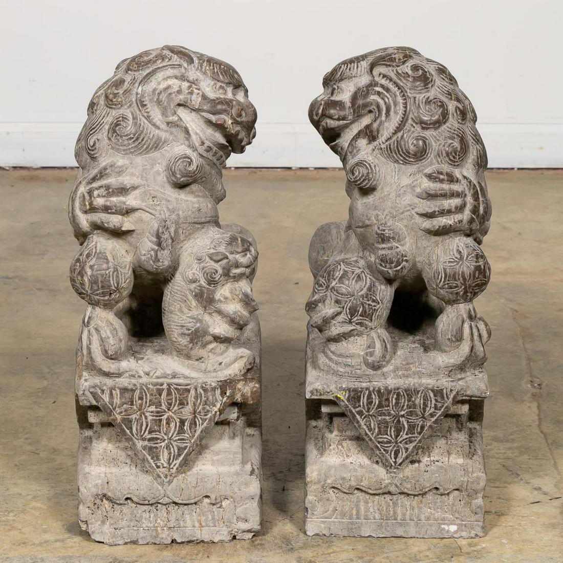 Pair, Chinese Limestone Guardian Lion Sculptures: Chinese. Pair of carved limestone male and female guardian lions of the usual form on a patterned plinth. Unmarked. Approx. of one. h. 20.5", w. 11.5", d. 7.75".