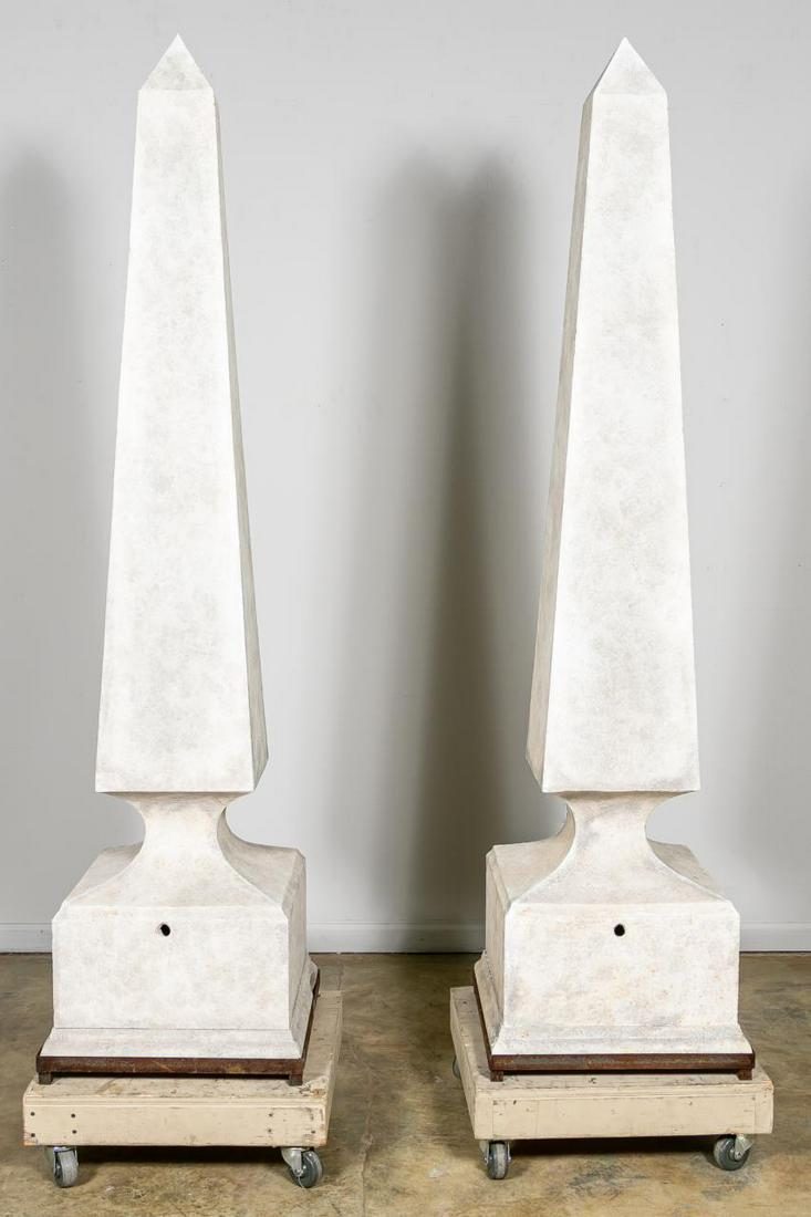 Pair, Monumental Cast Stone Garden Obelisks: Possibly American or European, 20th century. Pair of hollow cast stone obelisks having a concave waist, beveled plinth and resting on an iron base. Unmarked. Approx. h. 84", sq. 21.5".