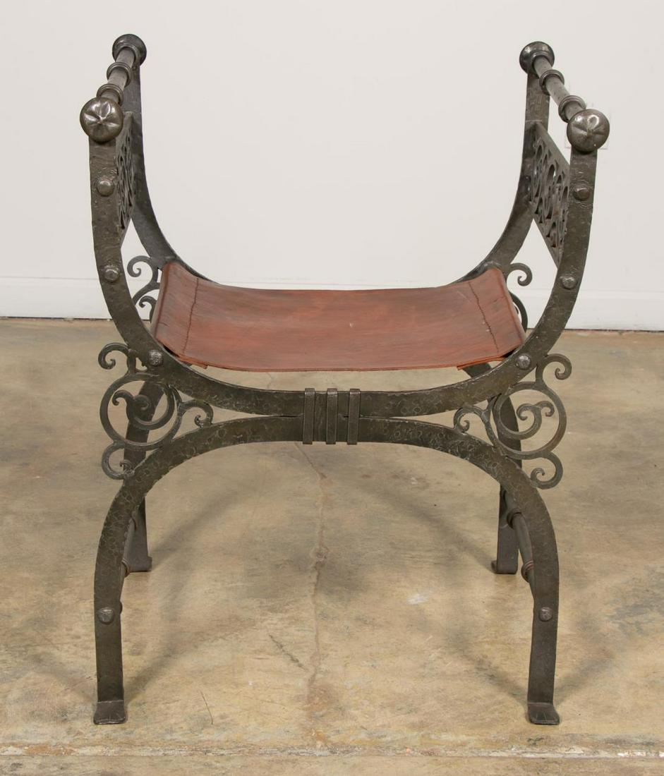 Italian Renaissance Style Iron and Leather Bench: Italian, 20th century. Curule bench having a hammered iron finish, open scrollwork arms and leather seat. Unmarked. Approx. h. 30.5", w. 23.25", d. 18.5".