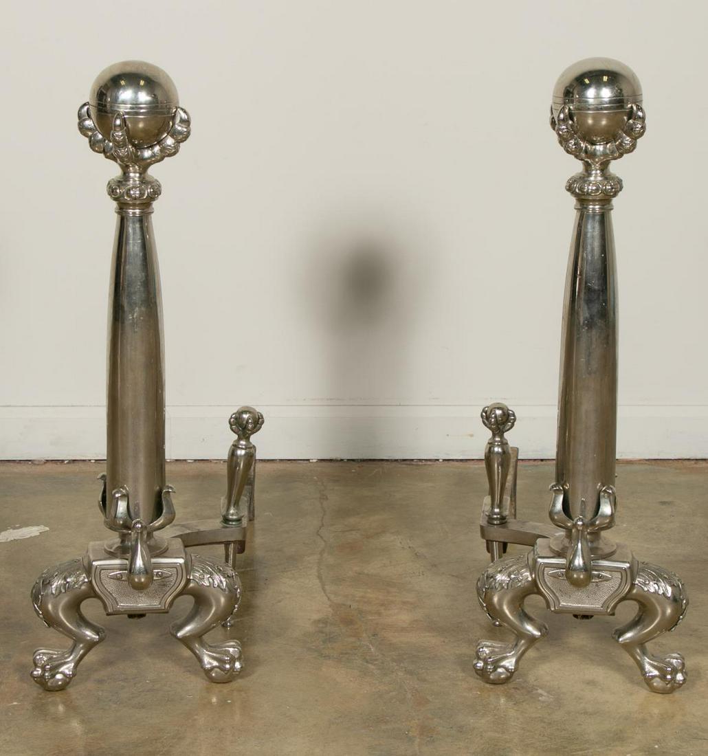 Pair, Silver Plated Claw and Ball Foot Andirons: American or English, late 19th century. Pair of silver plated andirons with large ball and claw finial topped columns raised on two paw feet with similar claw and ball log stopper supports behind. App